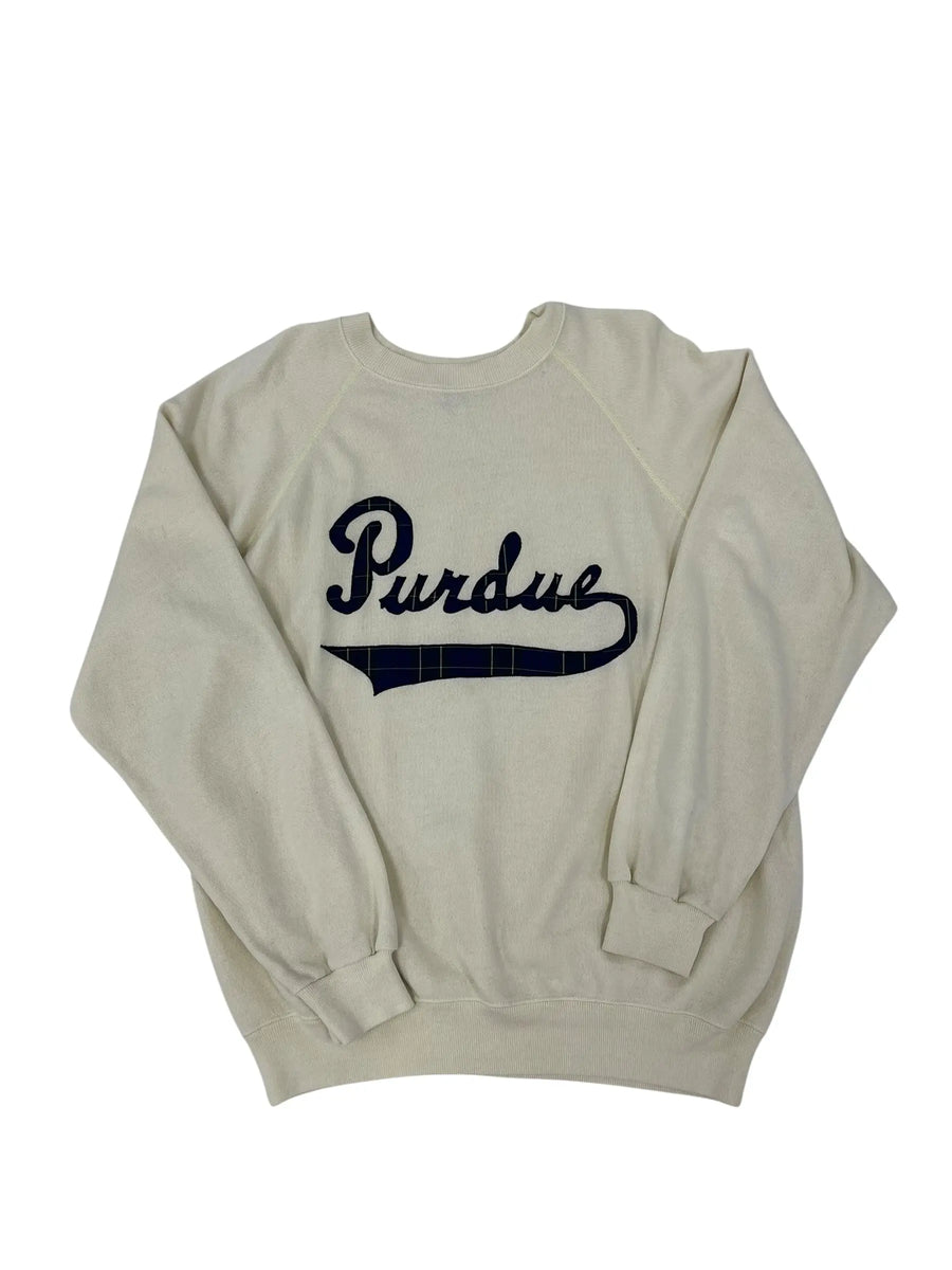 An off-white long-sleeve sweatshirt with 'Purdue' printed in navy blue script across the chest, laid flat on a white background.