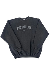 A dark charcoal gray sweatshirt with 'PURDUE' printed vertically in white on the front, folded neatly on a solid white background.