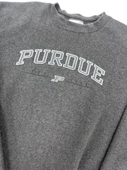 Close-up of a dark heather gray t-shirt featuring a white and gray 'PURDUE' graphic printed vertically on the chest.
