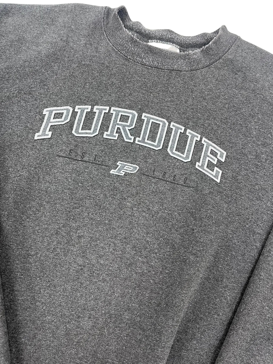 Close-up of a dark heather gray t-shirt featuring a white and gray 'PURDUE' graphic printed vertically on the chest.